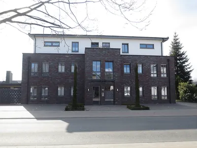 Mehrfamilienhaus aus dunklem Klinker mit hellem Staffelgeschoss. Rhede, Krechtinger Straße (Großansicht)